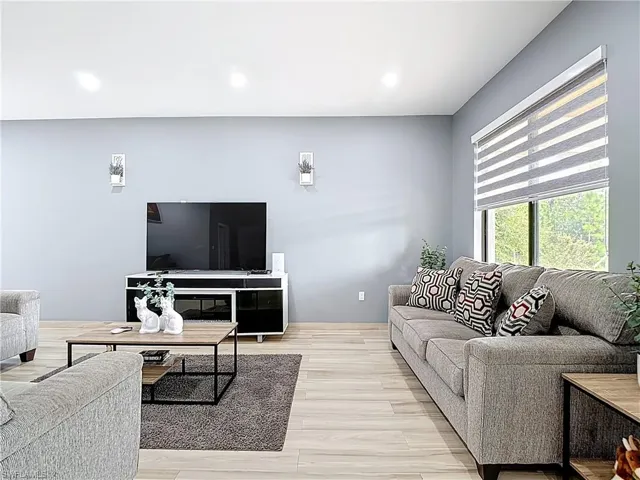 Living area featuring wood finished floors and recessed lighting