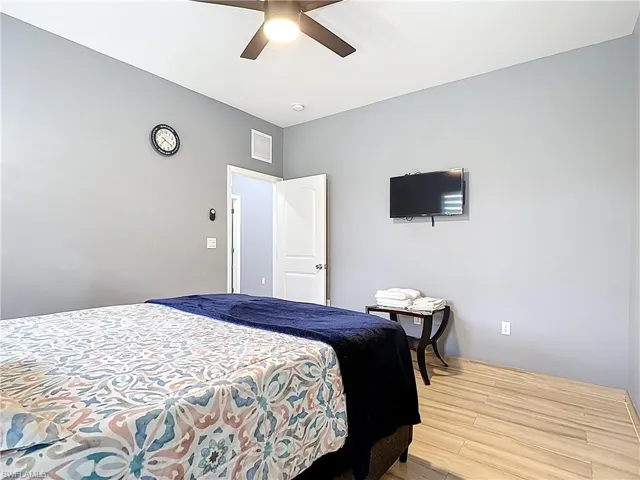 Bedroom with wood finished floors and a ceiling fan