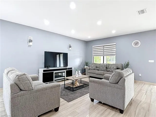 Living room featuring recessed lighting and light wood finished floors