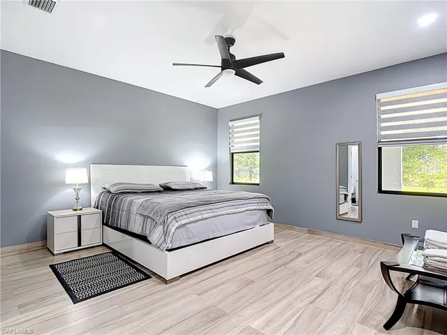 Bedroom with light wood-style flooring and a ceiling fan