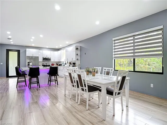Dining room with recessed lighting and light wood-style floors