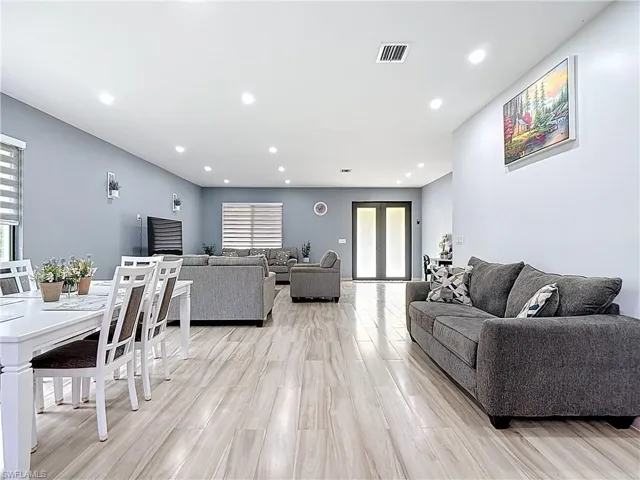 Living area with recessed lighting, light wood-style flooring, and french doors