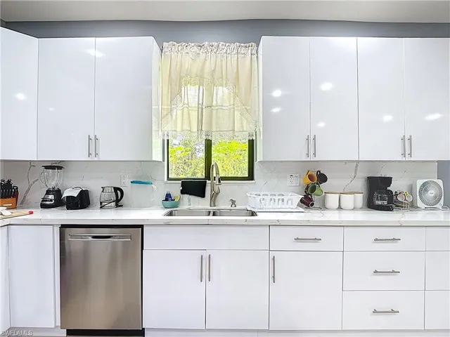 Kitchen featuring white cabinets