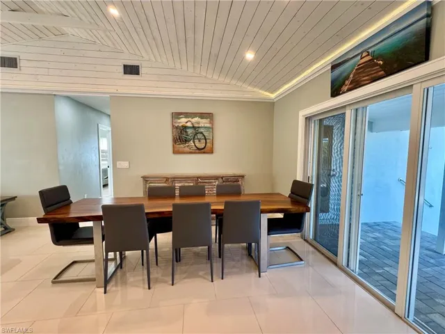 Dining space featuring plenty of natural light, lofted ceiling, and wood ceiling