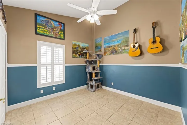Unfurnished room with tile patterned flooring, baseboards, ceiling fan, and vaulted ceiling