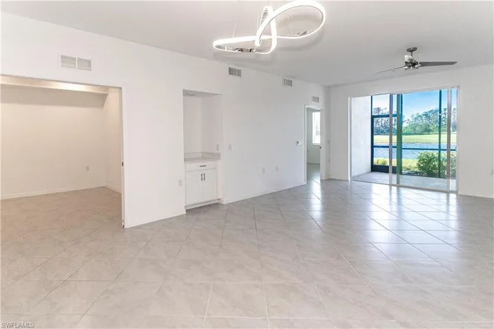 Empty room featuring ceiling fan and light tile patterned flooring