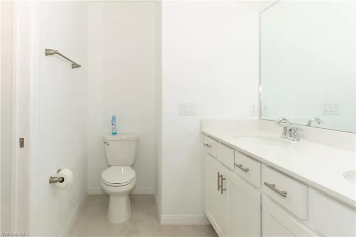 Bathroom with tile patterned flooring, vanity, and toilet