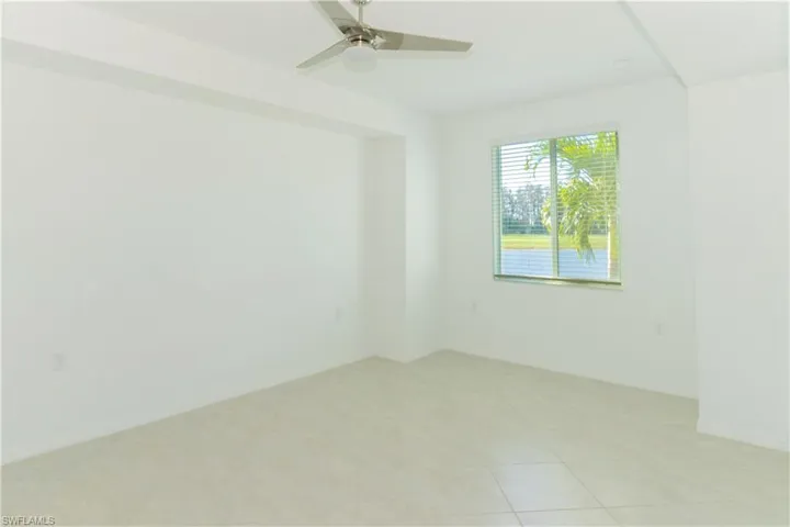 Unfurnished room featuring light tile patterned floors and ceiling fan