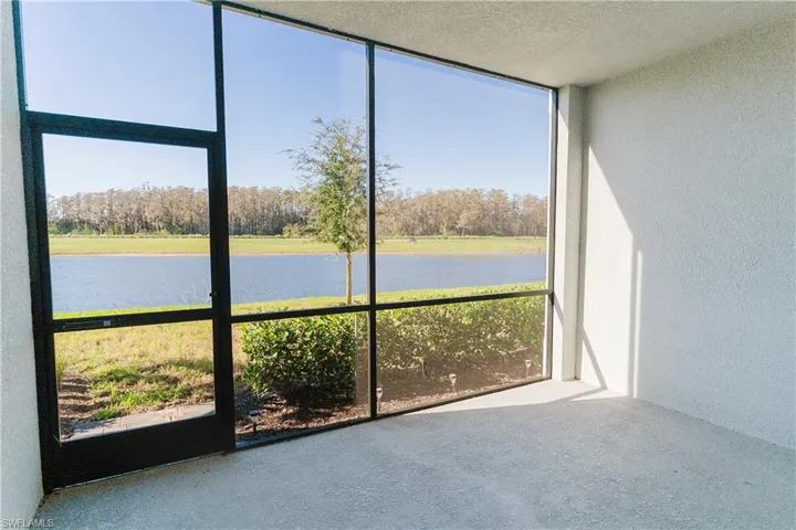 Unfurnished sunroom featuring a water view