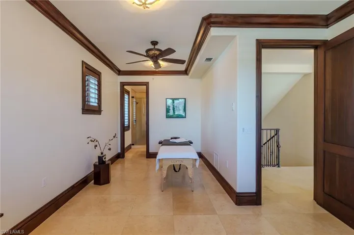 Hall with ornamental molding and an upstairs landing