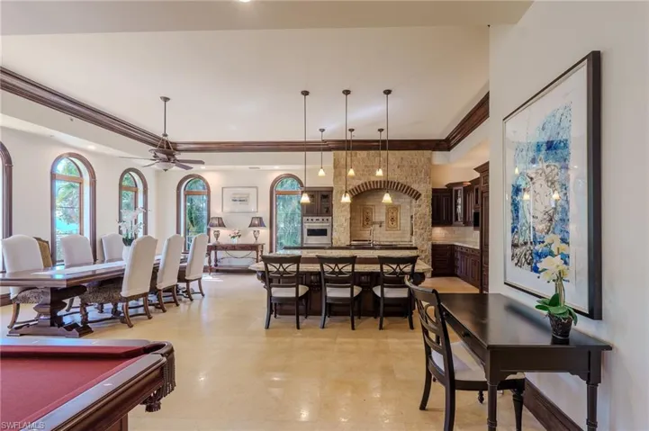 Dining space featuring billiards, a ceiling fan, ornamental molding, recessed lighting, and a tray ceiling