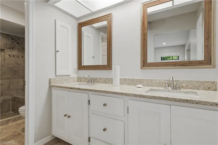 Dual vanity with light-toned countertop and integrated sinks