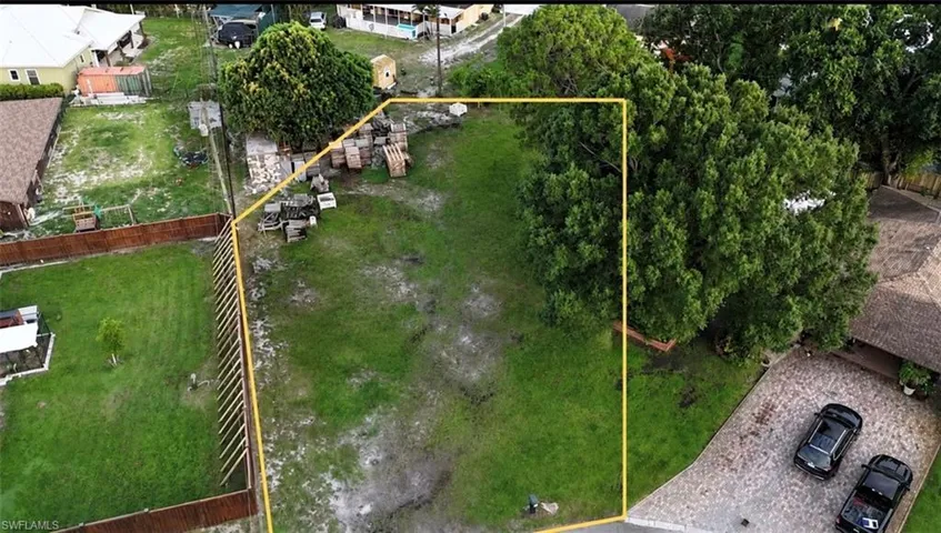 Expansive property featuring a grassy lot with mature trees
