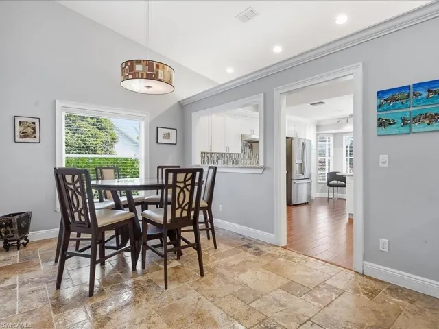 Dining space with plenty of natural light, stone tile floors, and recessed lighting