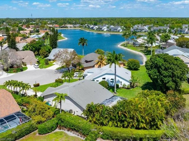 Aerial view of residential area featuring a nearby body of water