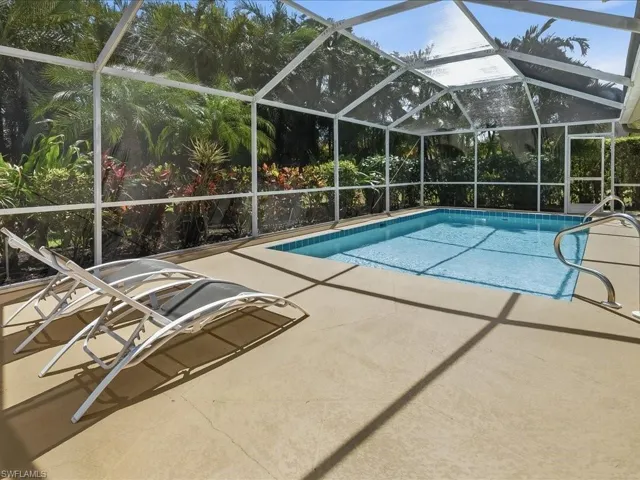 Swimming pool featuring a lanai and a patio area