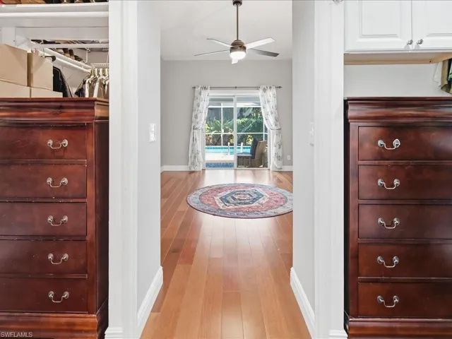 Corridor with baseboards and light wood-style flooring