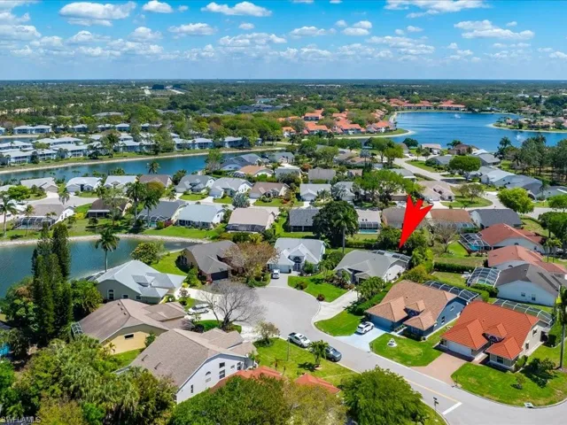 Aerial view of residential area featuring a large body of water
