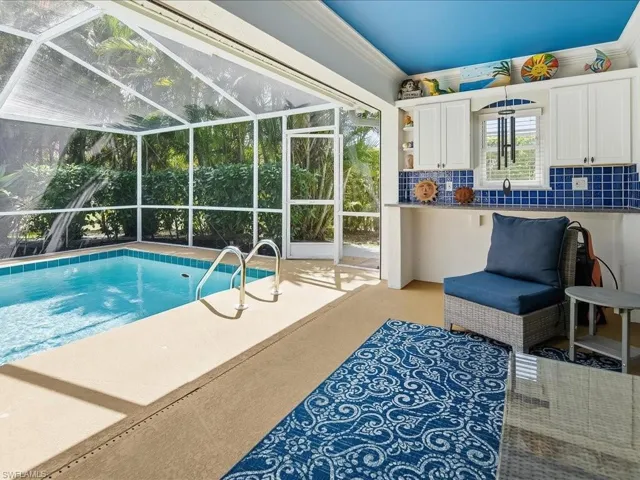 Outdoor pool featuring a sunroom