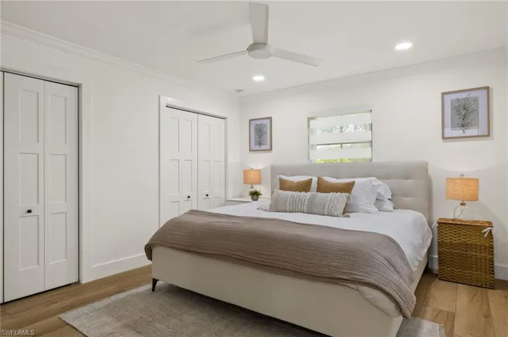 Bedroom featuring two closets and light hardwood / wood-style flooring