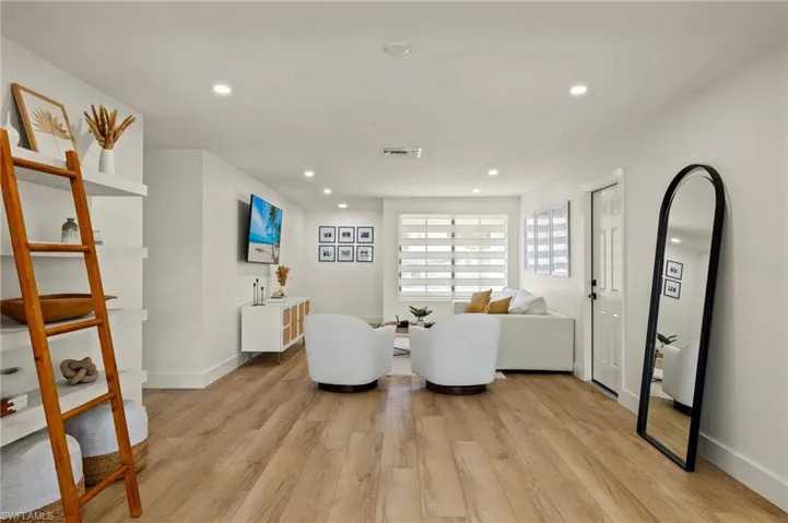 Living room with light hardwood / wood-style floors