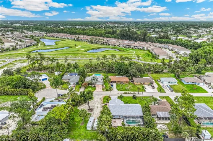 Aerial overview showcasing residential properties amidst lush greenery
