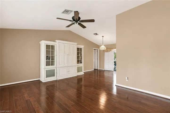 Virtual Wall Color. Vaulted ceiling featuring a ceiling fan, wood flooring.