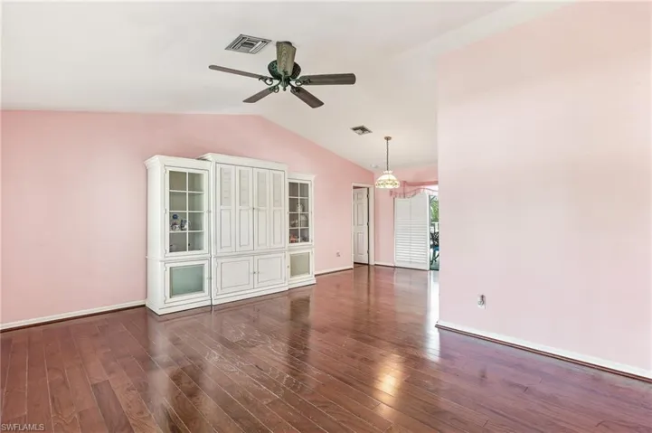 Spacious interior featuring high vaulted ceilings, wood flooring.