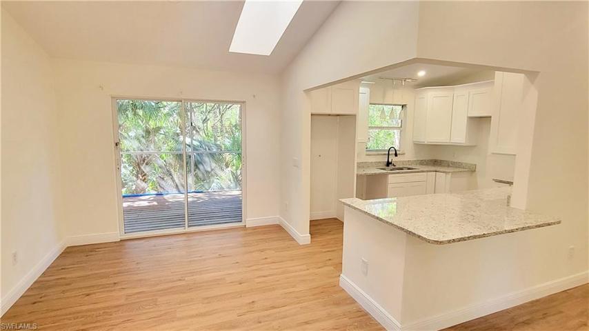 Kitchen/dining area with access to the screened deck.