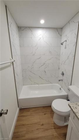 Guest bathroom with brand new tub, tiles, flooring, vanity, toilet
