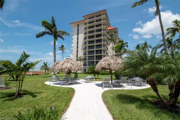 View of home's community with a patio area and a lawn