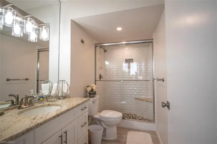 Full bathroom featuring vanity and a stall shower