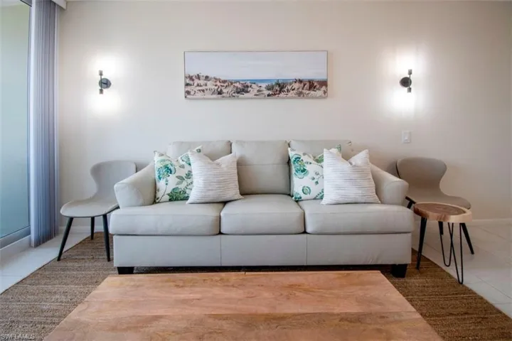 Tiled living area featuring baseboards