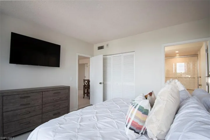 Bedroom featuring ensuite bath and a closet