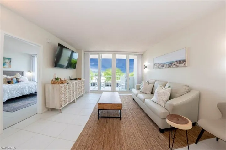 Living area with expansive windows and light tile patterned floors