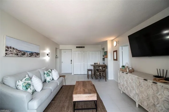 Tiled living room featuring a textured ceiling