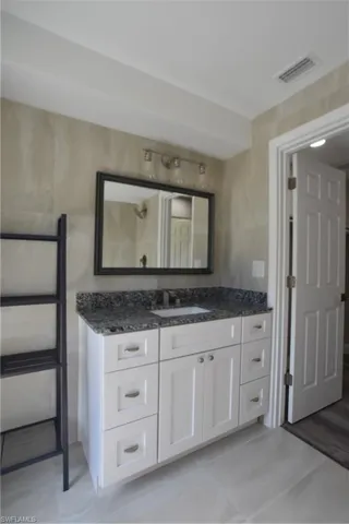 Bathroom with vanity and tile patterned flooring