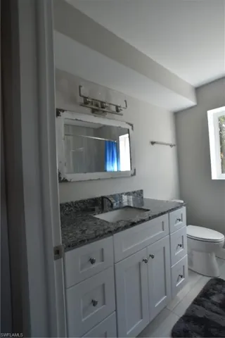 Full bathroom featuring vanity and curtained shower