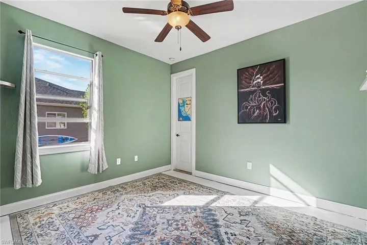 Unfurnished room featuring baseboards and ceiling fan