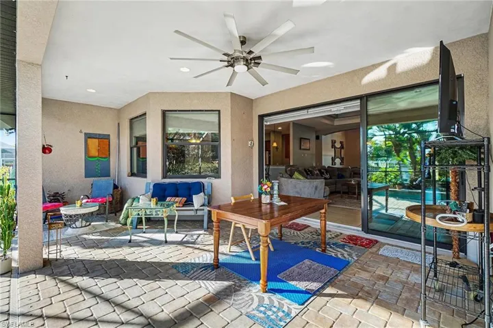 View of patio / terrace with a ceiling fan, an outdoor living space, and outdoor dining space
