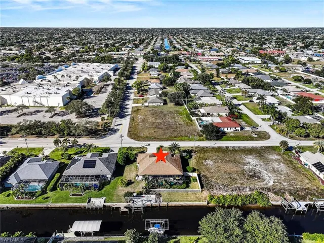 Aerial view of property and surrounding area with nearby suburban area