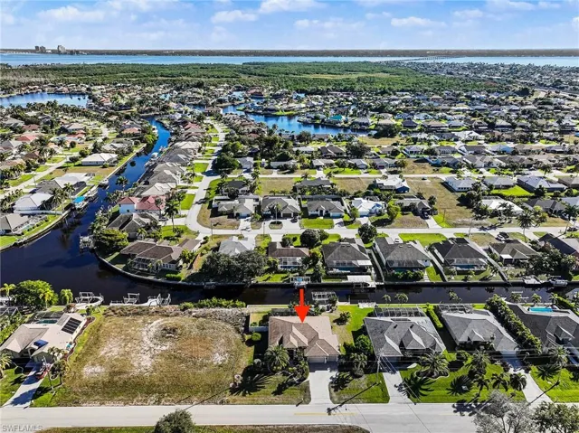Aerial perspective of suburban area with a nearby body of water