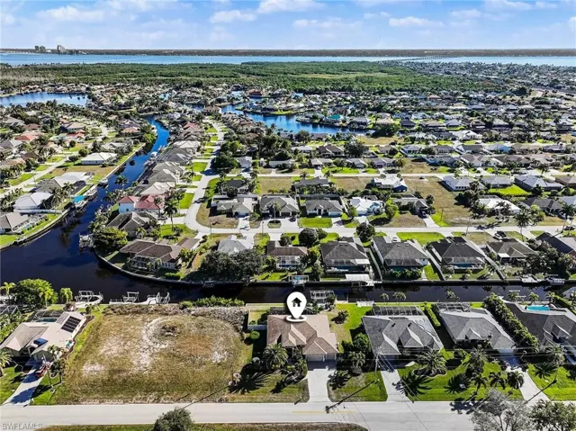 Aerial perspective of suburban area with a nearby body of water