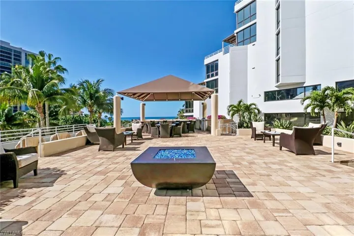 View of patio / terrace featuring an outdoor living space with a fire pit and a water view