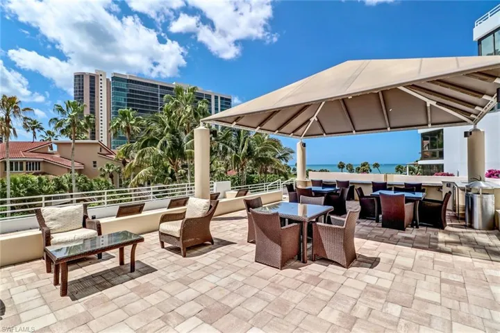 View of patio with outdoor lounge area, outdoor dining space, a water view, and a gazebo