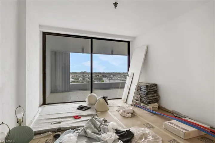 Unfurnished room with expansive windows and fire sprinkler in ceiling