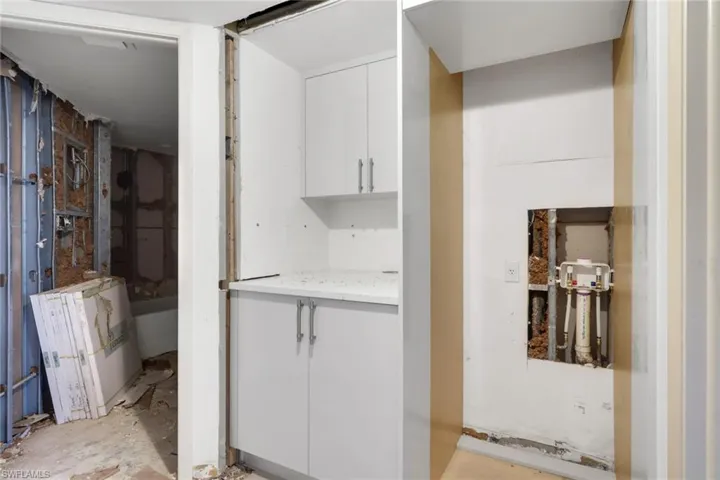 Kitchen featuring white cabinets and light stone countertops