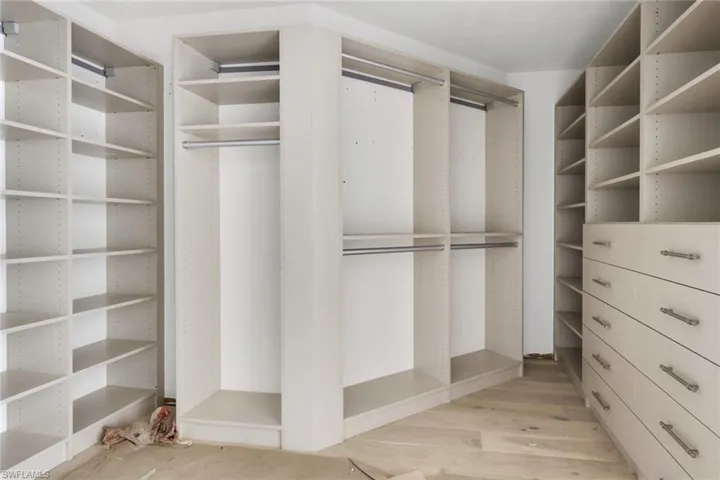 Spacious closet with light wood finished floors