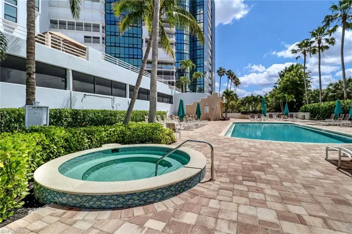 Community pool with a community hot tub and a patio