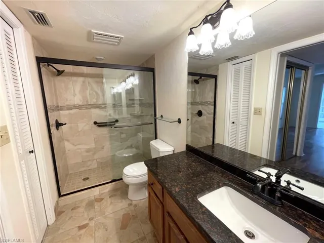 Guest bedroom has walk-in closet & private slider to Lania with   Gorgeous water views.